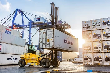 Hyster heavy duty top loader container handler moving a shipping container